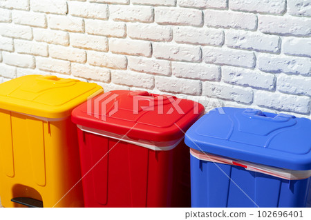 Three plastic trash bins against the wall in the building Three plastic trash bins against the wall in the building 102696401