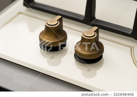 Knob switch on the electric stove close-up 102696408