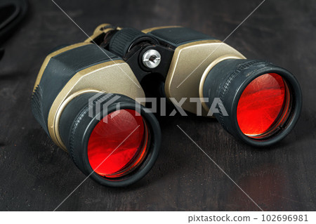 Hunting binoculars with red lense, close up 102696981