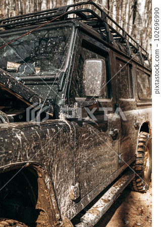 Dirty off road car on trip in forest 102696990