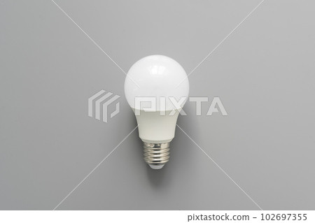 Light bulb on gray background close up 102697355