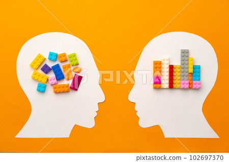 Papercut head silhouette with toy constructor pieces on yellow background 102697370