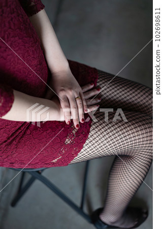 Woman sitting on a chair Wedding ring Sensual Woman sitting on a chair Wedding ring Sensual 102698611