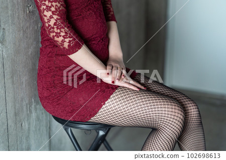 Woman sitting on a chair Wedding ring Sensual Woman sitting on a chair Wedding ring Sensual 102698613