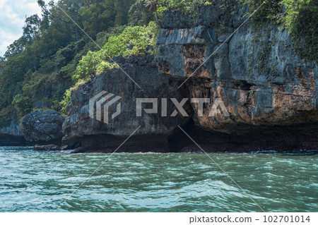 Rock formation on the ocean near the Tanjung Kasap or Cape Kasap, Pacitan, Indonesia. Taken from a moving boat. 102701014