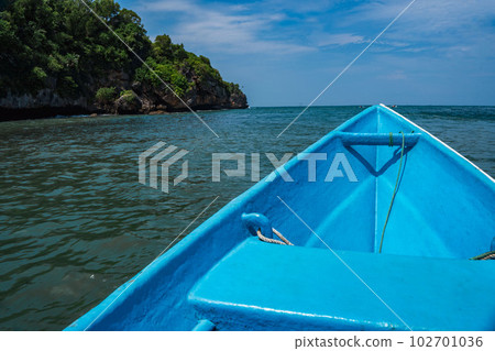 Sailing around the rocks on the ocean of Pacitan, Indonesia. Sailing around the rocks on the ocean of Pacitan, Indonesia. 102701036
