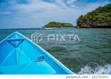 Sailing around the rocks on the ocean of Pacitan, Indonesia. Sailing around the rocks on the ocean of Pacitan, Indonesia. 102701037