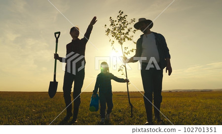 happy family child mother father tree plant sunset garden. smile laughter trust. agriculture. tree roots soil earth. tree trunk, senior farmer with child kid daughter girl plants tree garden, child 102701351
