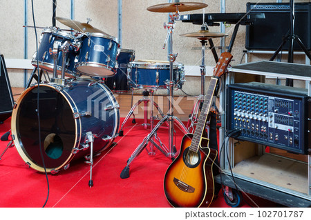 Modern music instruments and equipments for rock band in empty rehearsal room 102701787