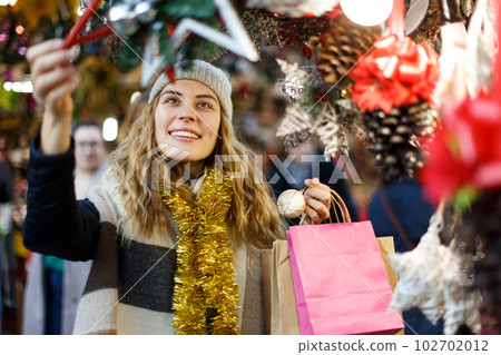 Young woman buying Christmas decorations Young woman buying Christmas decorations 102702012