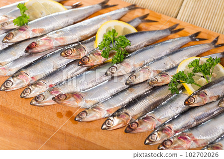 Anchovies served on wooden surface Anchovies served on wooden surface 102702026