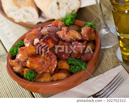 Morro de cerdo - spanish dish. Roast nose and cheek pigs with parsley Morro de cerdo - spanish dish. Roast nose and cheek pigs with parsley 102702322