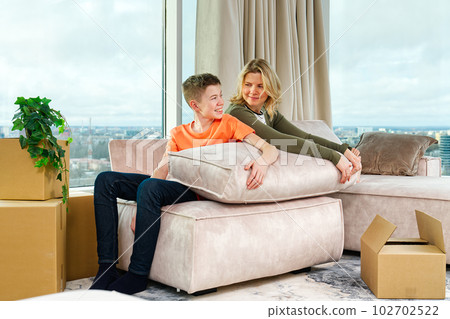 Family rearranging furniture Happy couple moving furniture in new apartment. Moving day happy buyers 102702522