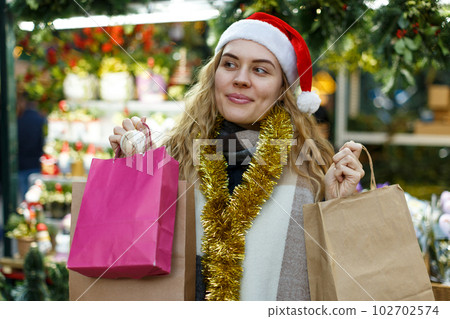 Woman holding bags with Christmas toys Woman holding bags with Christmas toys 102702574