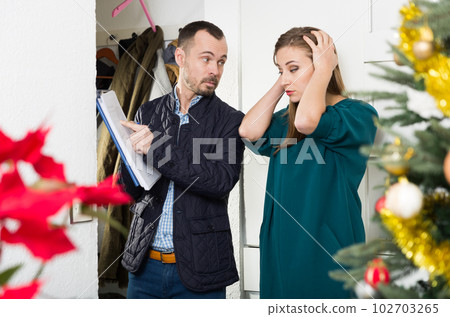 Debt collector and woman at doorway 102703265