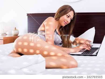 woman lying with laptop 102703503