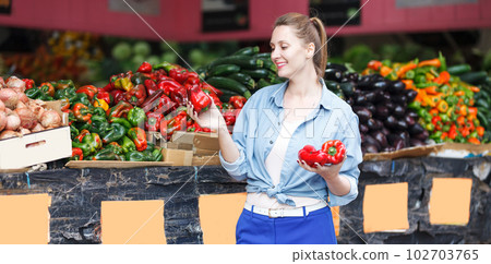 Woman is choosing fresh pepper 102703765