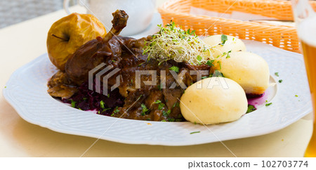Duck with yeast dumplings and blue cabbage Duck with yeast dumplings and blue cabbage 102703774