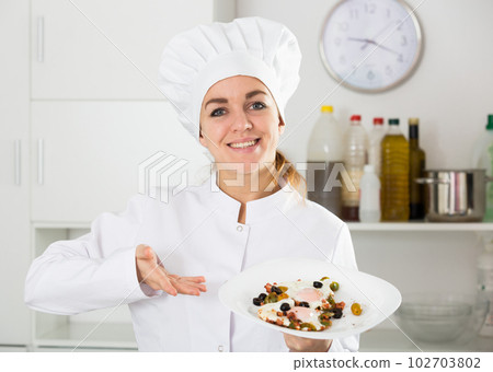Female cook preparing food 102703802