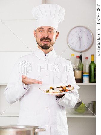 Male cook preparing food 102703807