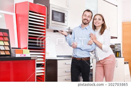 Couple choosing kitchen furniture materials 102703865