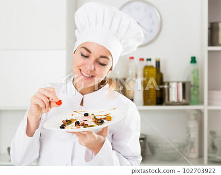 Female cook preparing food Female cook preparing food 102703922