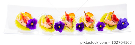 Ceviche of pickled salmon on kiwi with figs, cumquat 102704163