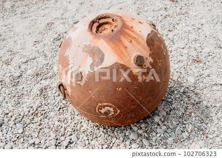 Old rusty sea mine on the beach. Old rusty sea mine on the beach. 102706323