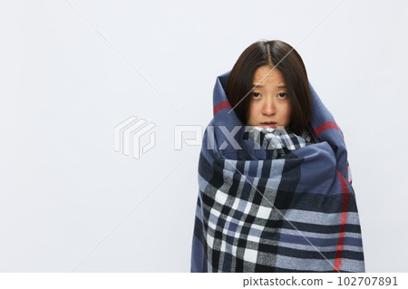Asian woman with cold flu in plaid with fever sick from covid 19 on white background Asian woman with cold flu in plaid with fever sick from covid 19 on white background 102707891