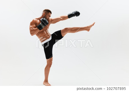 Man athletic bodybuilder poses in boxing gloves with nude torso abs in full-length background, boxing and martial arts. Advertising, sports, active lifestyle, competition, challenge concept. Man athletic bodybuilder poses in boxing gloves with nude torso abs in full-length background, boxing and martial arts. Advertising, sports, active lifestyle, competition, challenge concept. 102707895