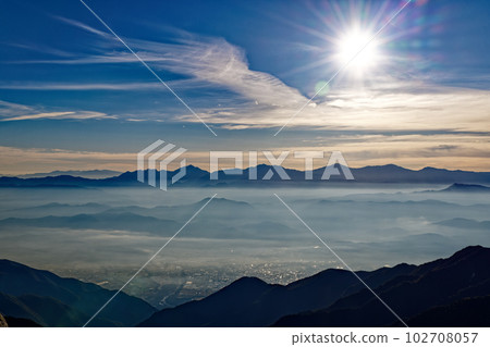 Mountain ranges of the Southern Alps floating in the morning mist seen from Mt. Kumazawa in the Central Alps 102708057