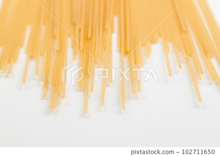 Spaghetti spread out on a white surface. Spaghetti spread out on a white surface. 102711650