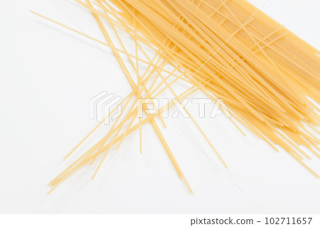 Spaghetti spread out on a white surface. Spaghetti spread out on a white surface. 102711657