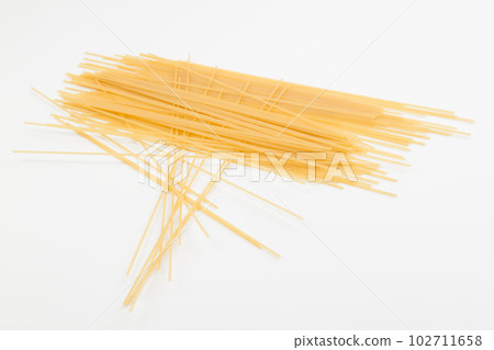 Spaghetti spread out on a white surface. Spaghetti spread out on a white surface. 102711658
