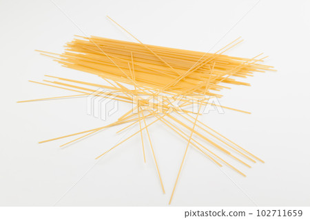 Spaghetti spread out on a white surface. Spaghetti spread out on a white surface. 102711659