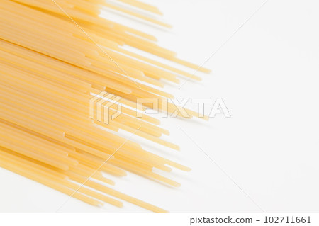Spaghetti spread out on a white surface. Spaghetti spread out on a white surface. 102711661