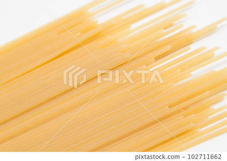 Spaghetti spread out on a white surface. Spaghetti spread out on a white surface. 102711662
