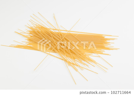 Spaghetti spread out on a white surface. Spaghetti spread out on a white surface. 102711664