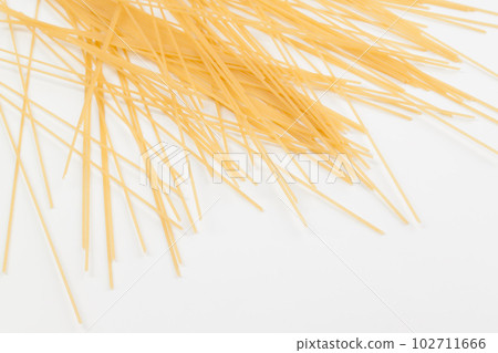 Spaghetti spread out on a white surface. Spaghetti spread out on a white surface. 102711666