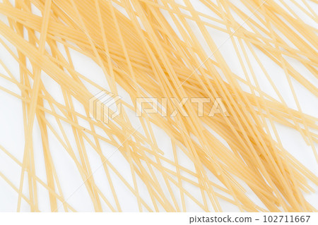 Spaghetti spread out on a white surface. Spaghetti spread out on a white surface. 102711667
