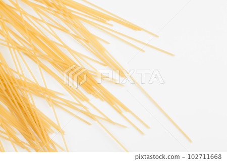 Spaghetti spread out on a white surface. Spaghetti spread out on a white surface. 102711668