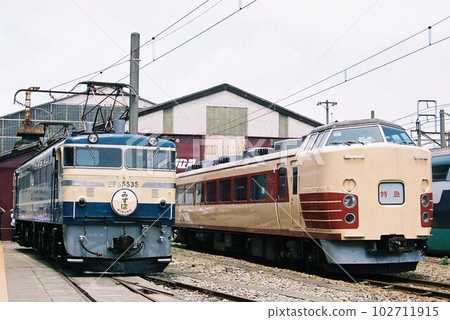 EF65 type electric locomotive and 183 series train lined up at the depot 102711915
