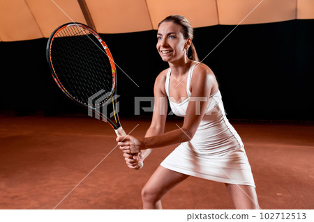 Sportswoman at the tennis court with racquet. 102712513
