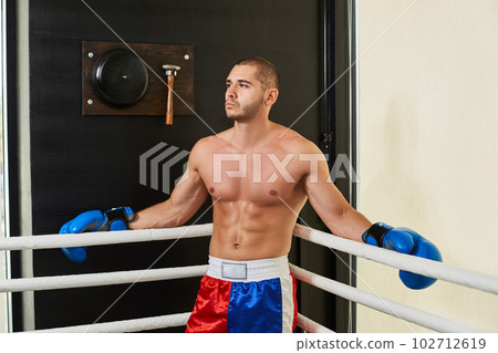 Boxer man standing in a corner of the ring 102712619