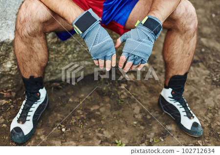 Close up of fit man wearing bandage on his hand 102712634