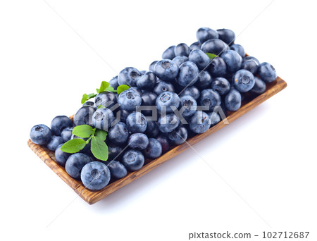 blueberries in wooden dish isolated on white blueberries in wooden dish isolated on white 102712687