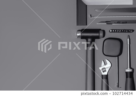 Flat lay composition with set of home repair tools on grey stone background. Top view pattern with copy space. Flat lay composition with set of home repair tools on grey stone background. Top view pattern with copy space. 102714434