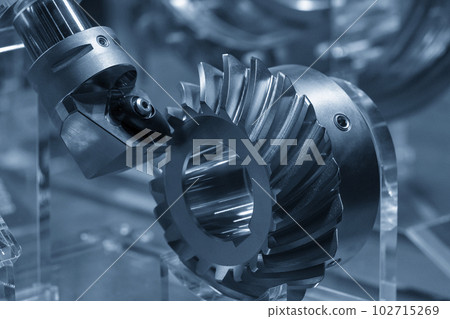 Close up the spiral bevel gear part and the lathe tool in the light blue scene. Close up the spiral bevel gear part and the lathe tool in the light blue scene. 102715269