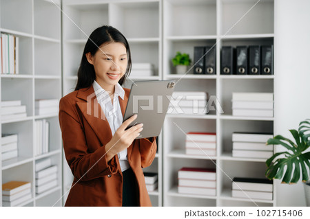 Business woman using tablet and laptop for doing math finance on an office desk, tax, report, accounting, statistics, and analytical research concept in office Business woman using tablet and laptop for doing math finance on an office desk, tax, report, accounting, statistics, and analytical research concept in office 102715406