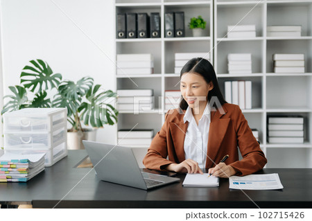 Business woman using tablet and laptop for doing math finance on an office desk, tax, report, accounting, statistics, and analytical research concept in office Business woman using tablet and laptop for doing math finance on an office desk, tax, report, accounting, statistics, and analytical research concept in office 102715426